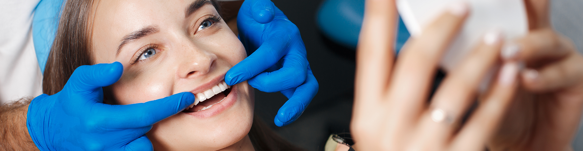 Gloved hands frmaing woman's smile